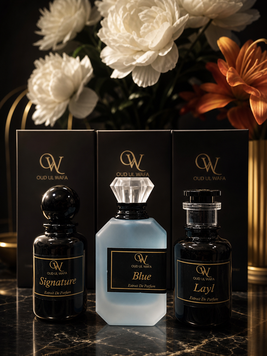 three perfume bottles of long lasting fragrance of oud ul wafa are placed on a table