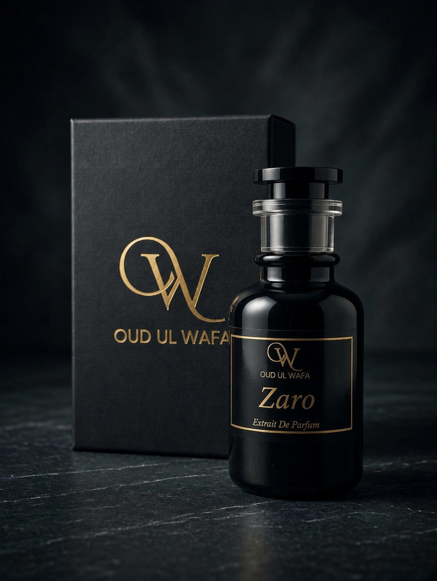 A black glass perfume bottle labeled 'Zaro' by Oud Ul Wafa stands in front of a matching black box with gold lettering on a dark studio background.