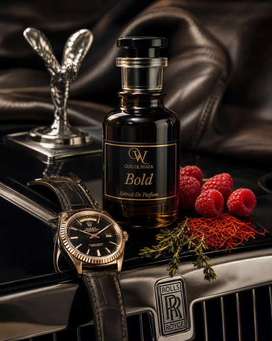 Bottle of Oud Ul Wese Bold perfume on a Rolls-Royce car hood with raspberries and a watch.ITS BOLD INSPIRED BU TUSCAN LEATHER , IT IS TOP SELLING PERFUME OF PAKISTAN, LONG LASTING PERFUME AND WE OFFER FREE DELIVERY ALL OVER PAKISTAN